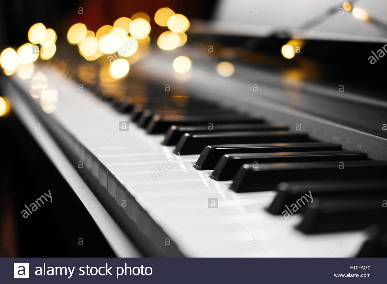 Piano Keys With Beautiful Yellow Lights Bokeh In Background