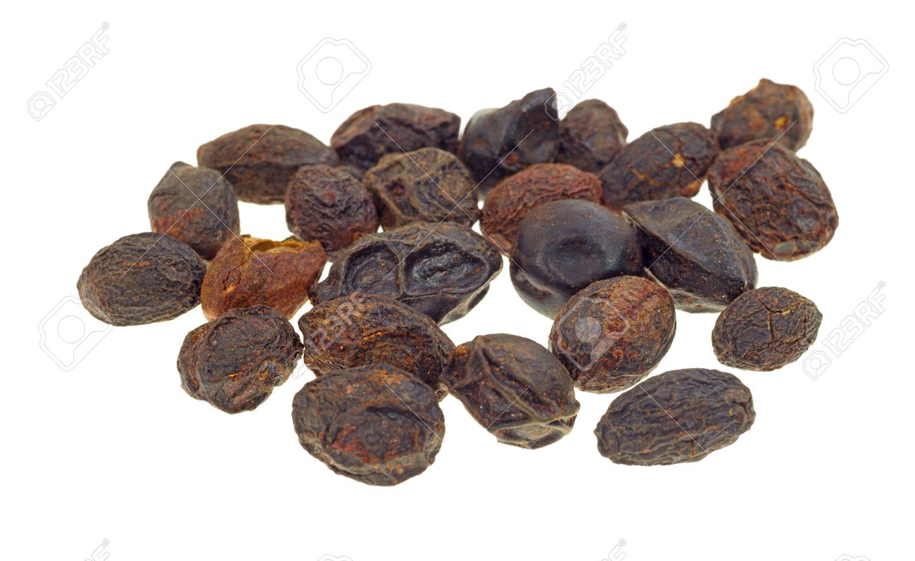 A Group Of Dried Saw Palmetto Berries On White Background Stock