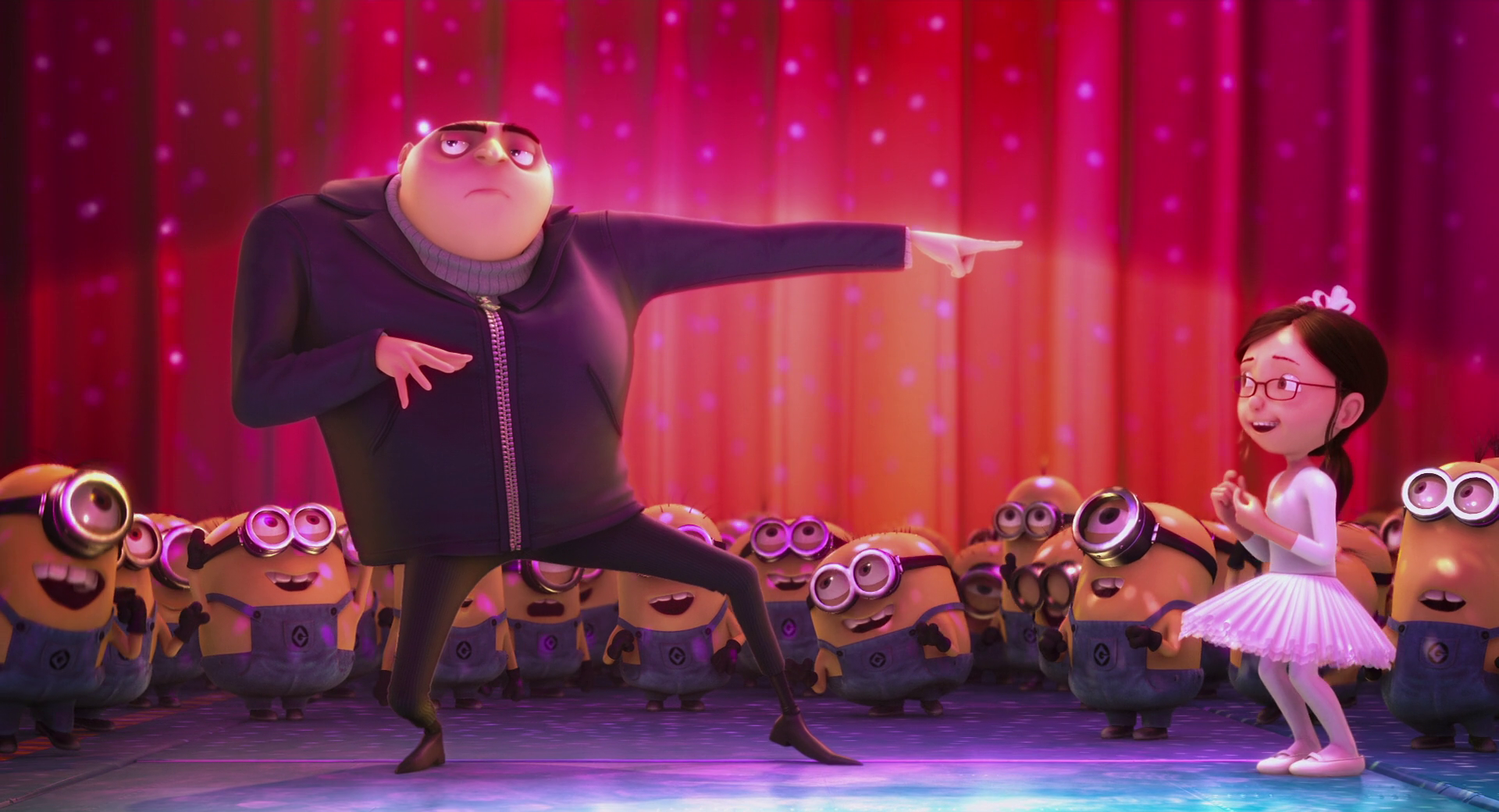Gru and Agnes perform a dance routine on stage with minions in Despicable Me 2