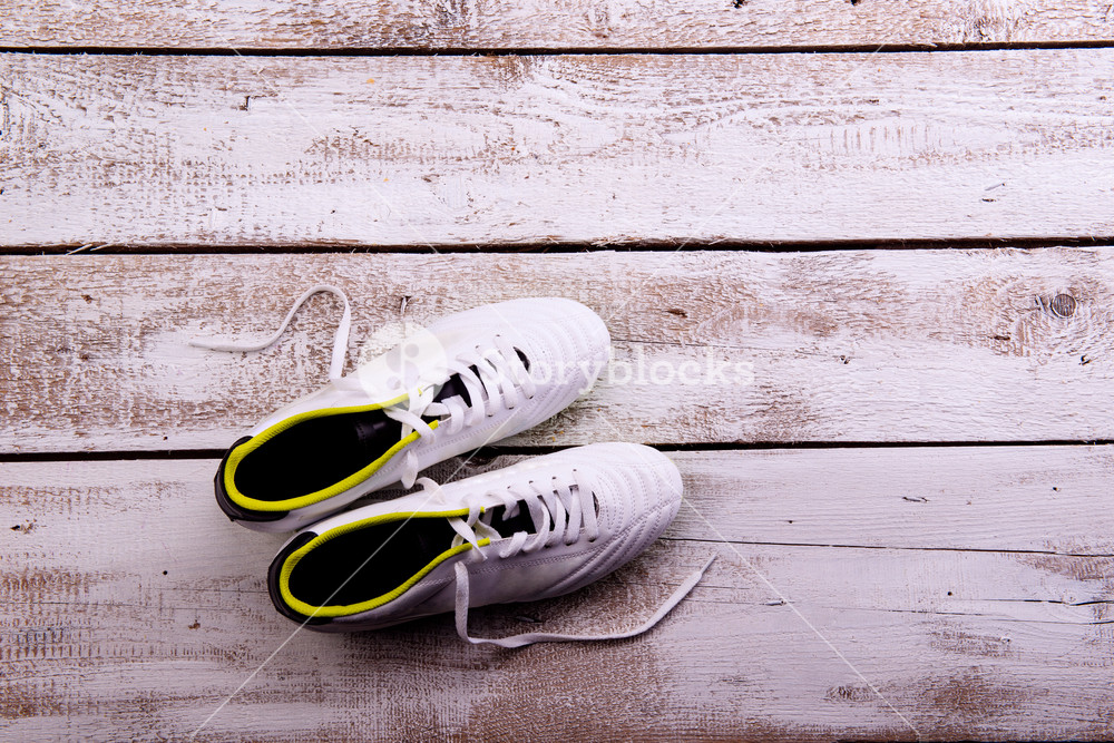 Soccer Cleats Against Wooden Floor Studio Shot On White