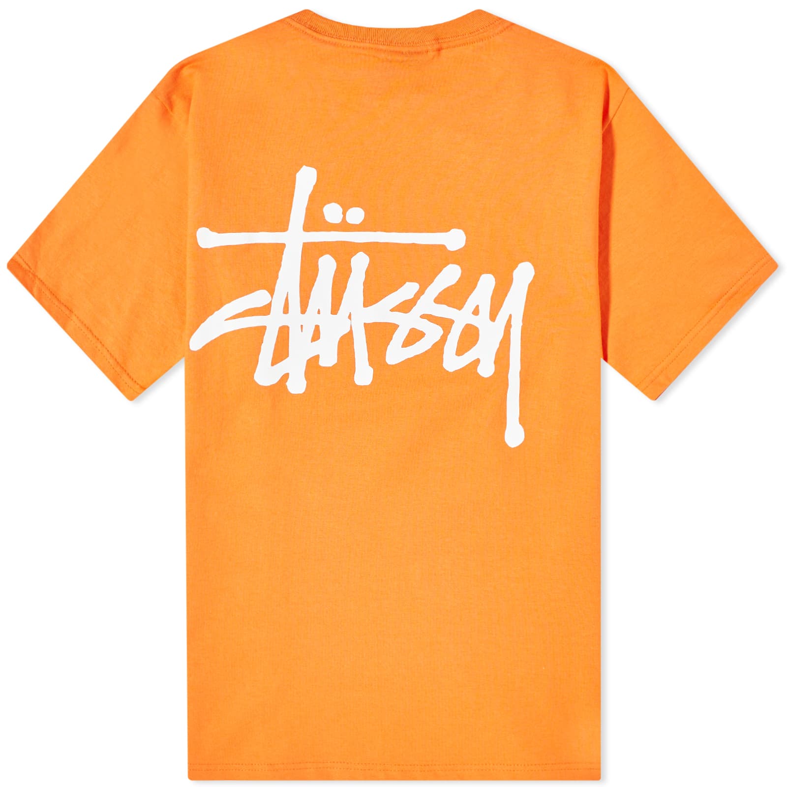 Close-up of a bright orange Stussy t-shirt featuring the iconic white Stussy logo on the back