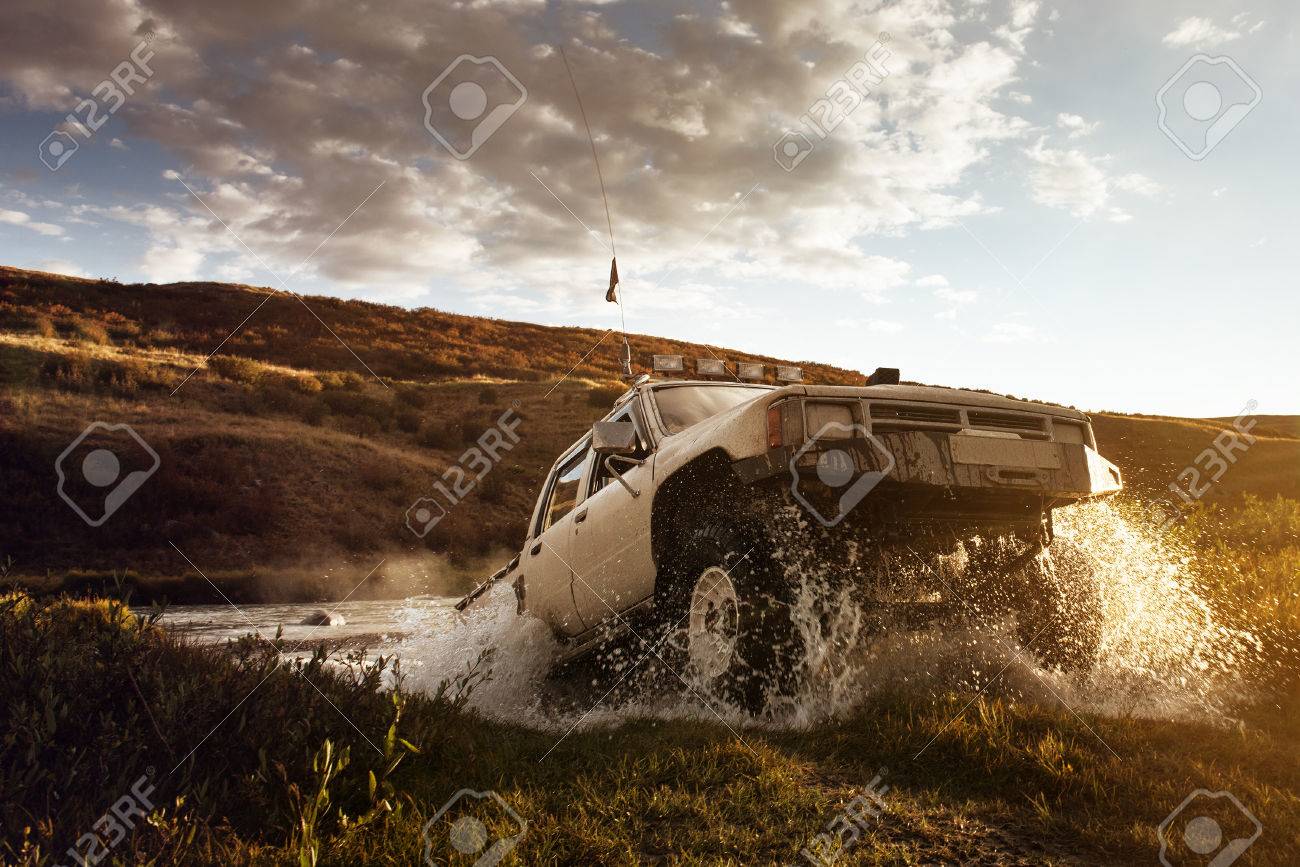 Car Suv Overes Water On The Offroad And Sky Background Stock