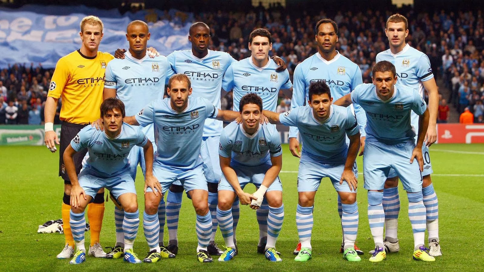 Manchester City football team posing for a photo on the field