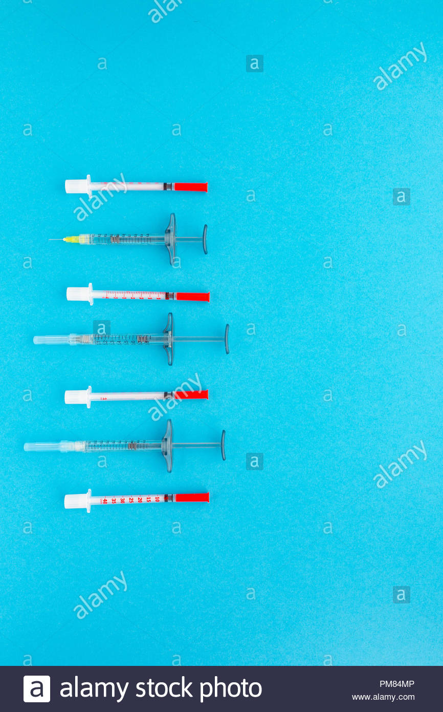 Syringes Organized In A Row Over Blue Background Top Mock