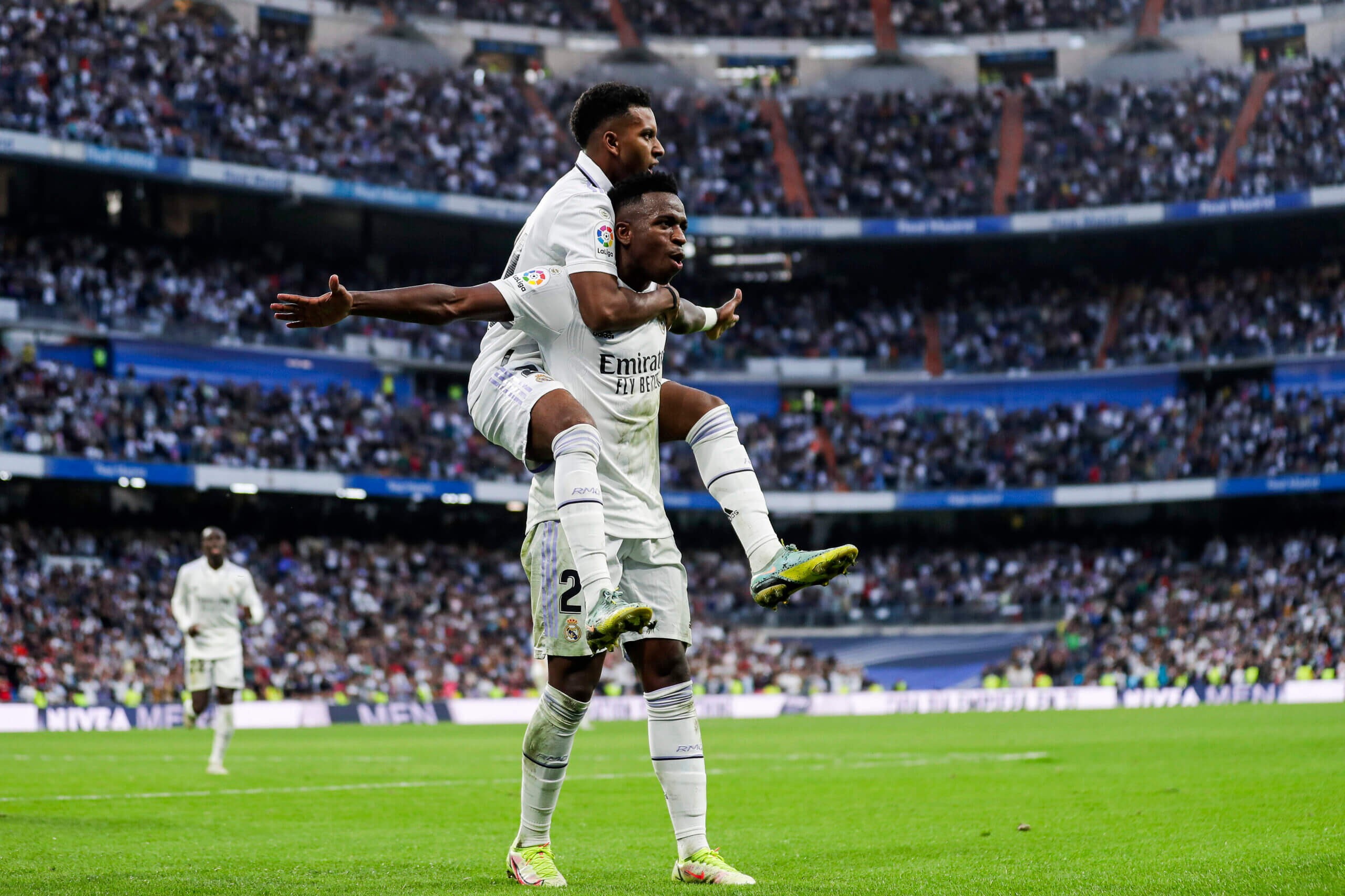 Two soccer players celebrating a goal