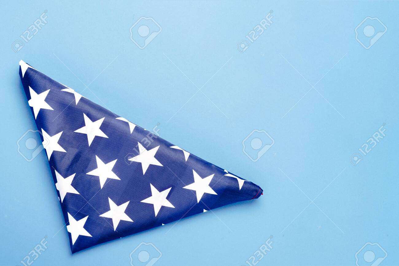 Folded Usa Flag On A Blue Background Concept Memorial Day
