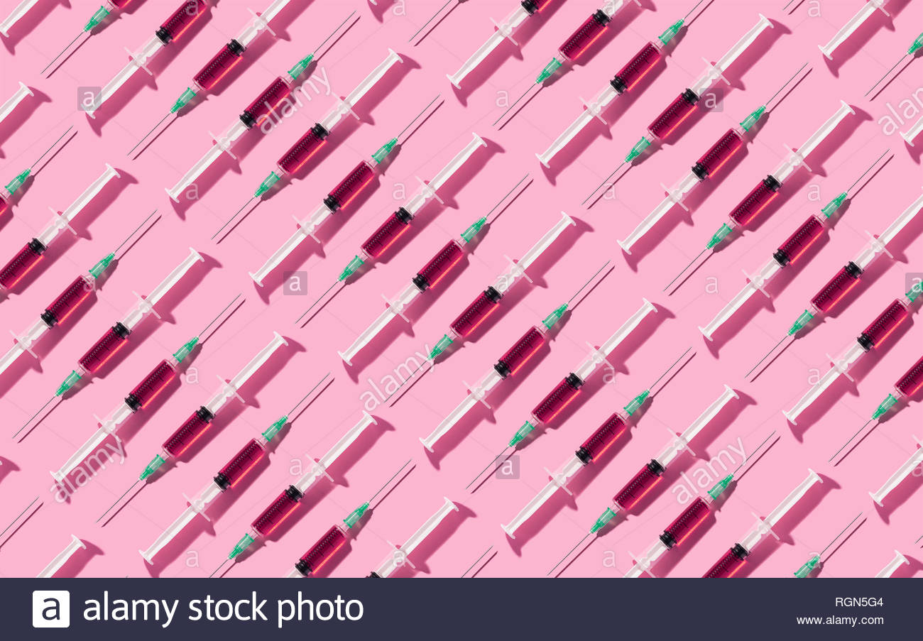 Multiple Syringes Anized In A Pattern Over Pink Background
