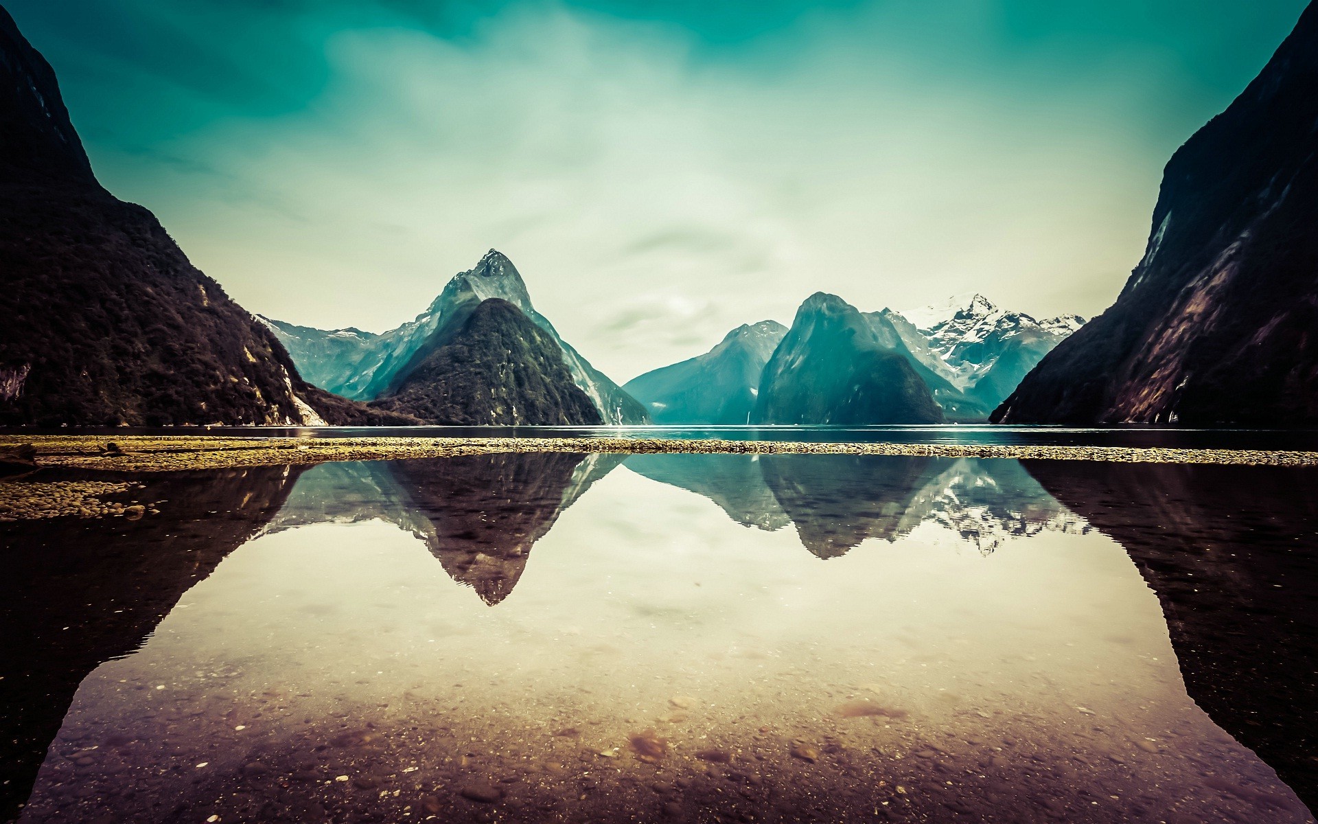 Stunning 4K wallpaper of a serene mountain lake reflection in Milford Sound, New Zealand