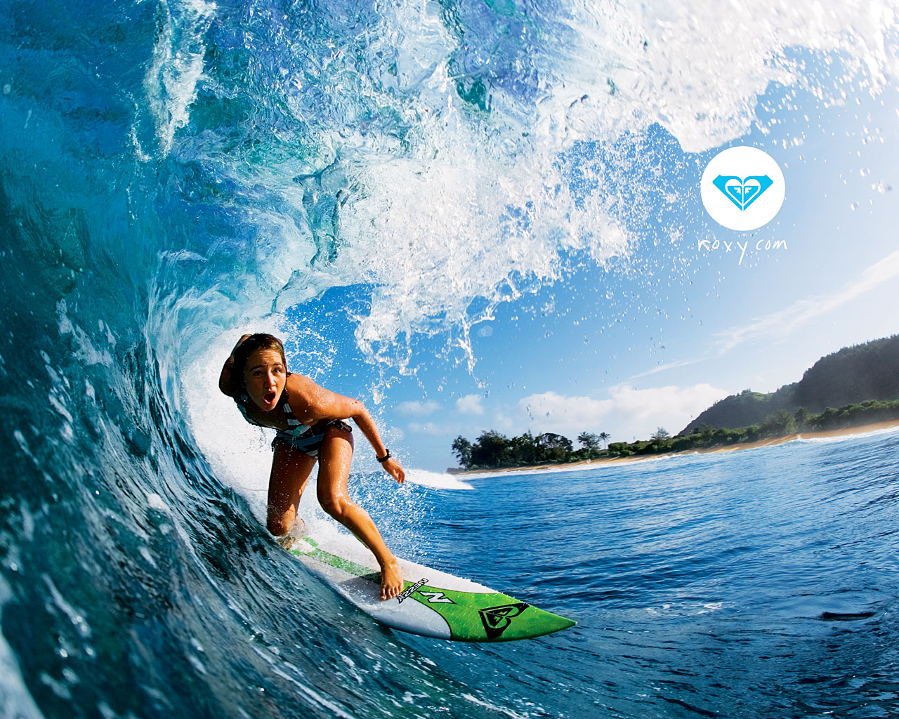 A female surfer rides a wave inside a hollow barrel, showcasing the thrill and power of surfing