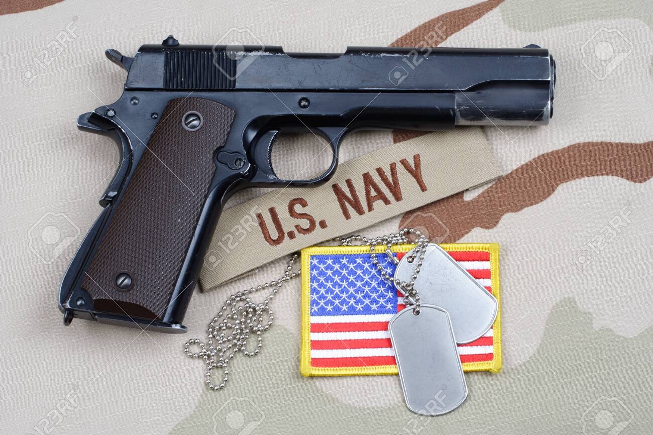 Colt Government With U S Navy Uniform Background Stock Photo