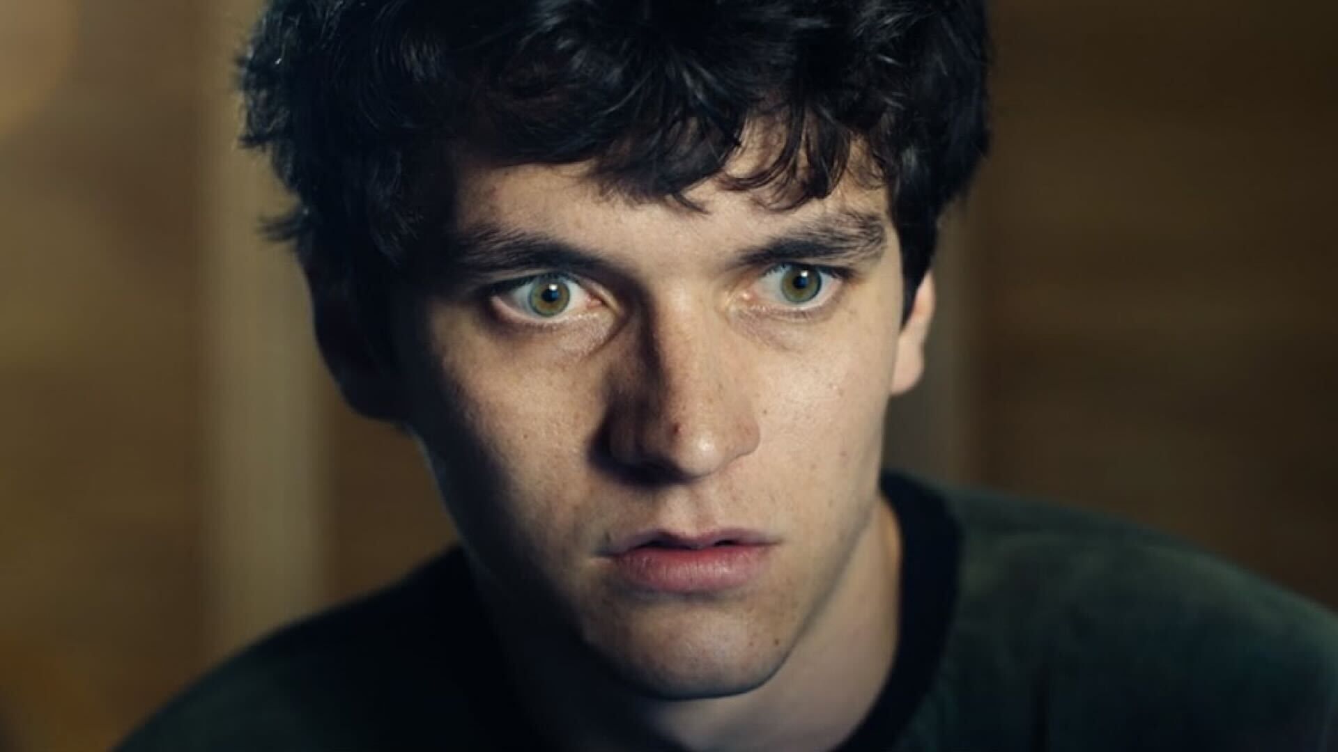 Close-up of a young man with a surprised expression, possibly from a still in a film or television show