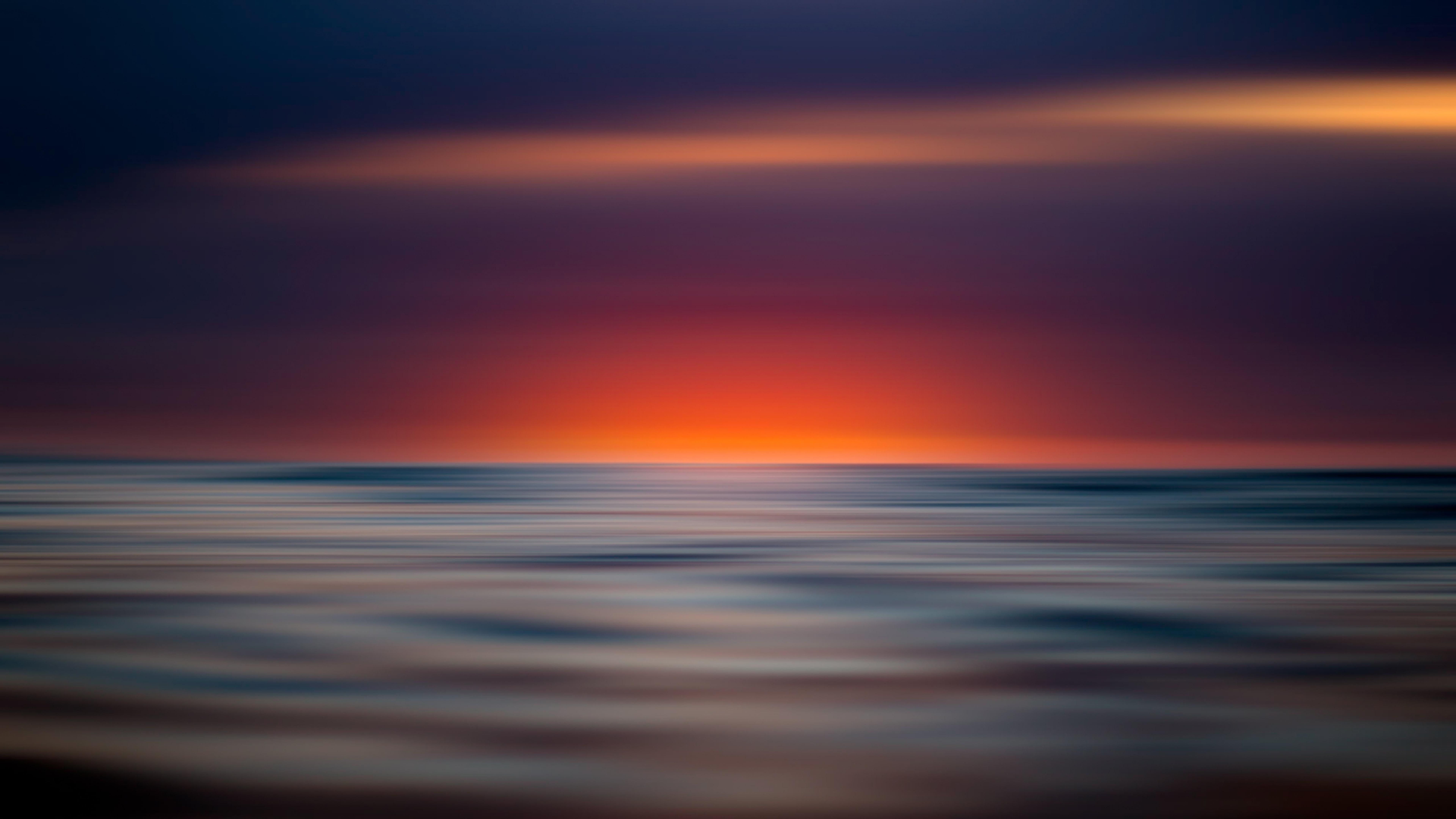 sunset water horizon sky sea calm ocean red sky wave