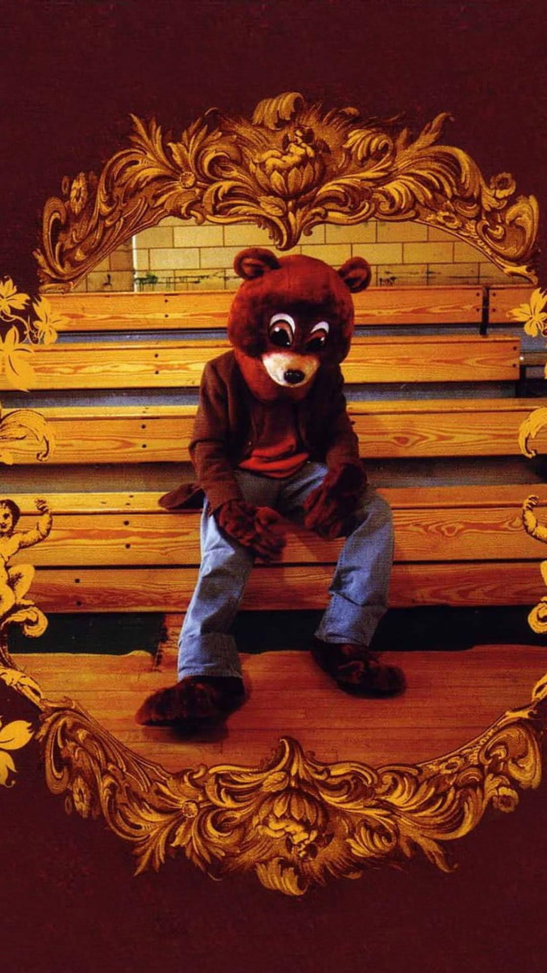 Download Kanye West Bear Mascot Costume On Bleachers Wallpaper