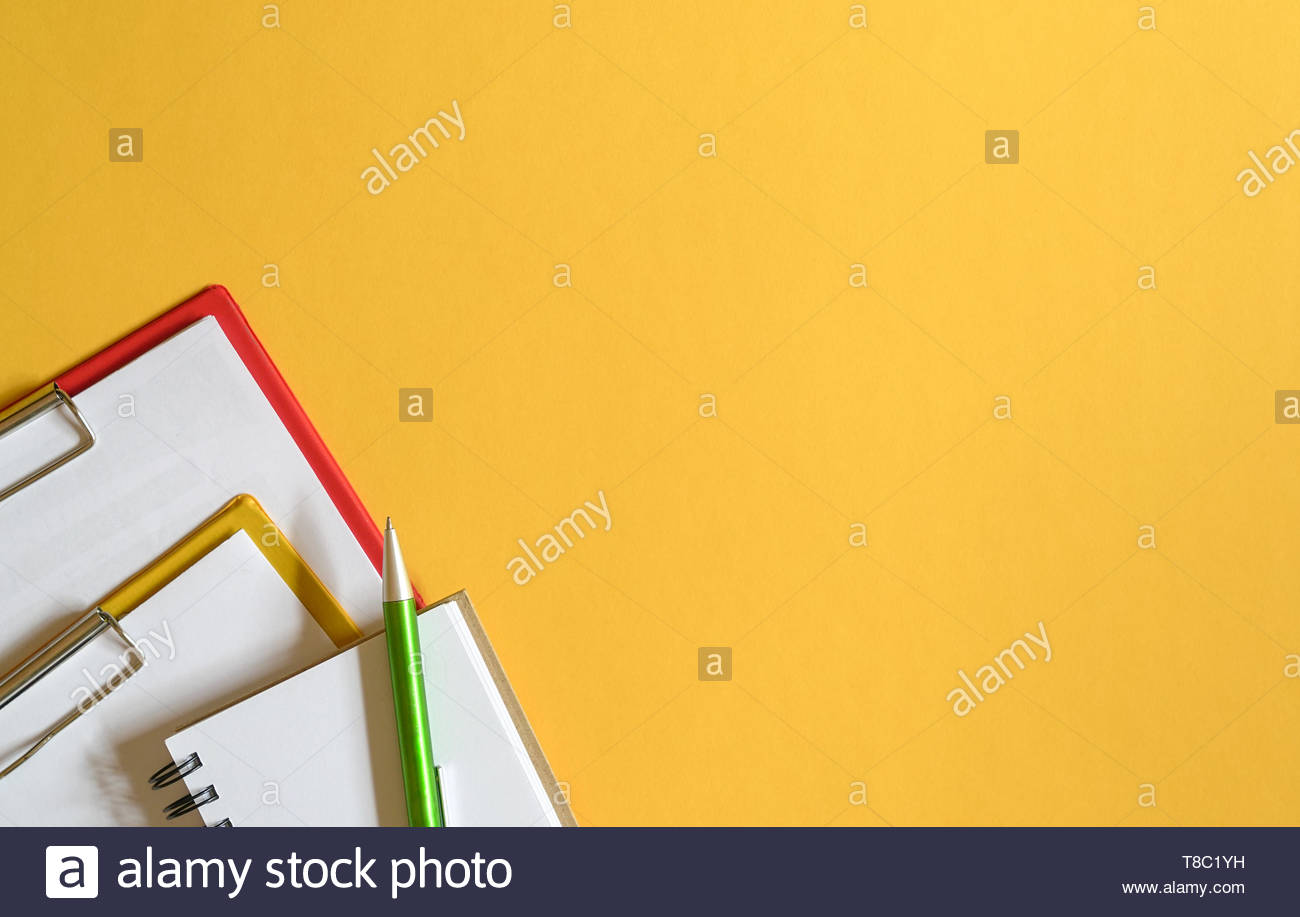 Clipboards Memo Pad And Green Pen On Yellow Top Or Desk