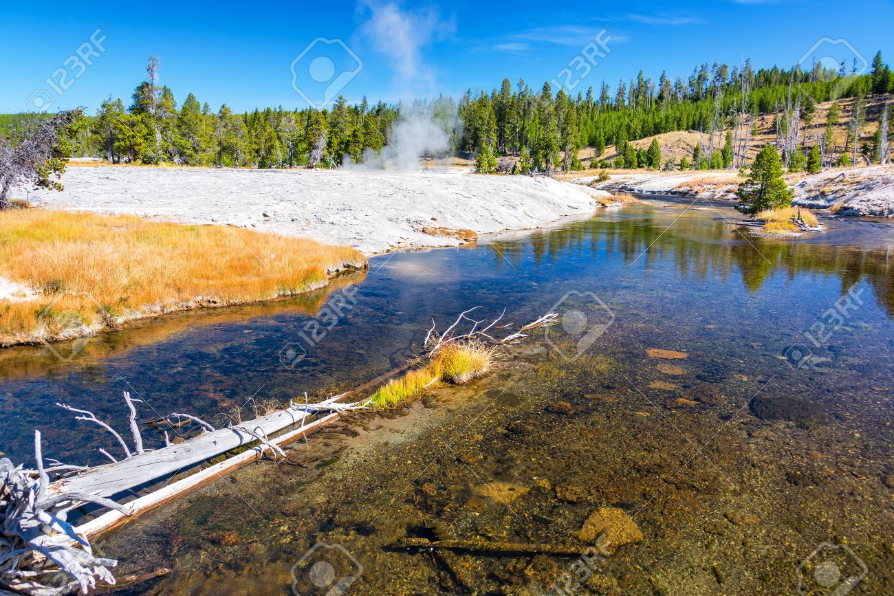 Firehole River With A Steaming Geyser In The Background