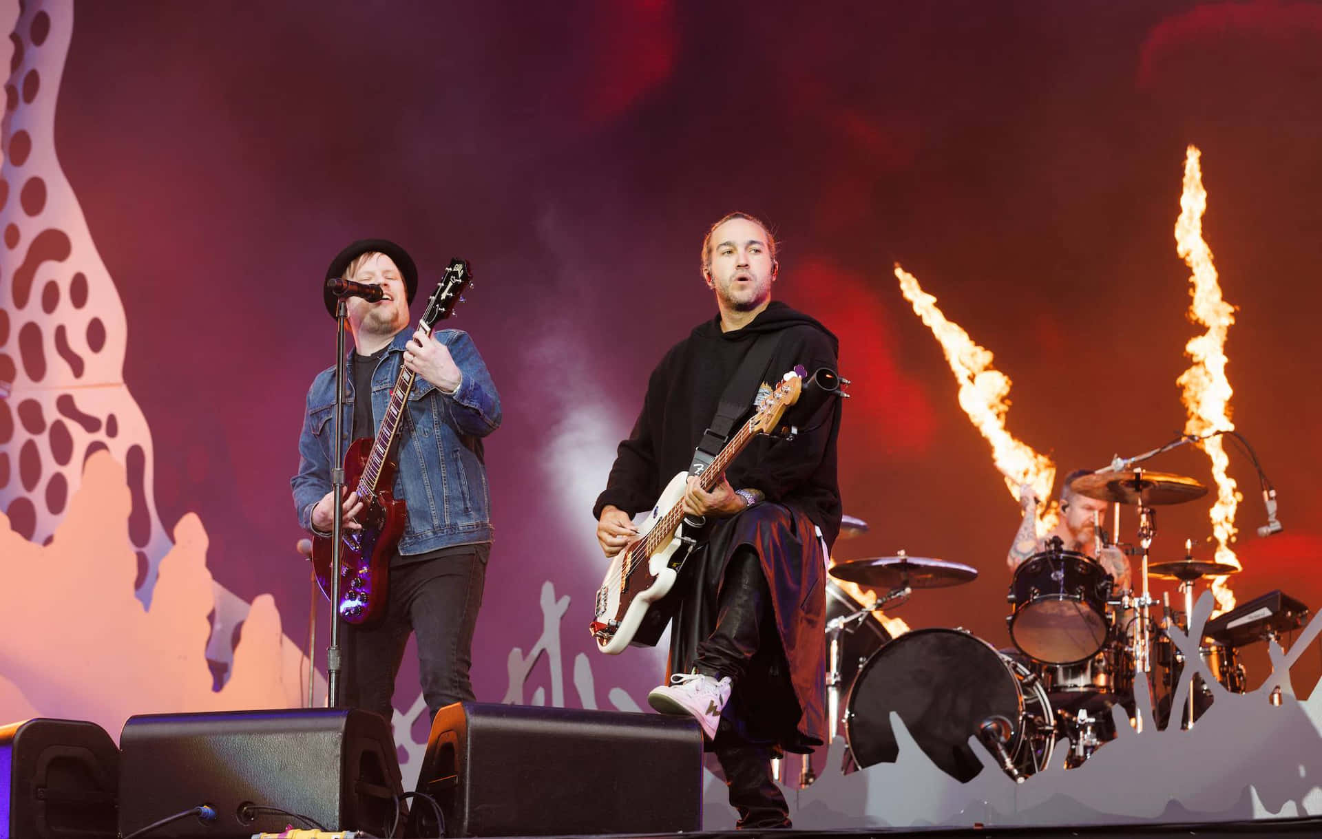Fall Out Boy performing live on stage, with Patrick Stump on vocals and guitar, and Pete Wentz on bass