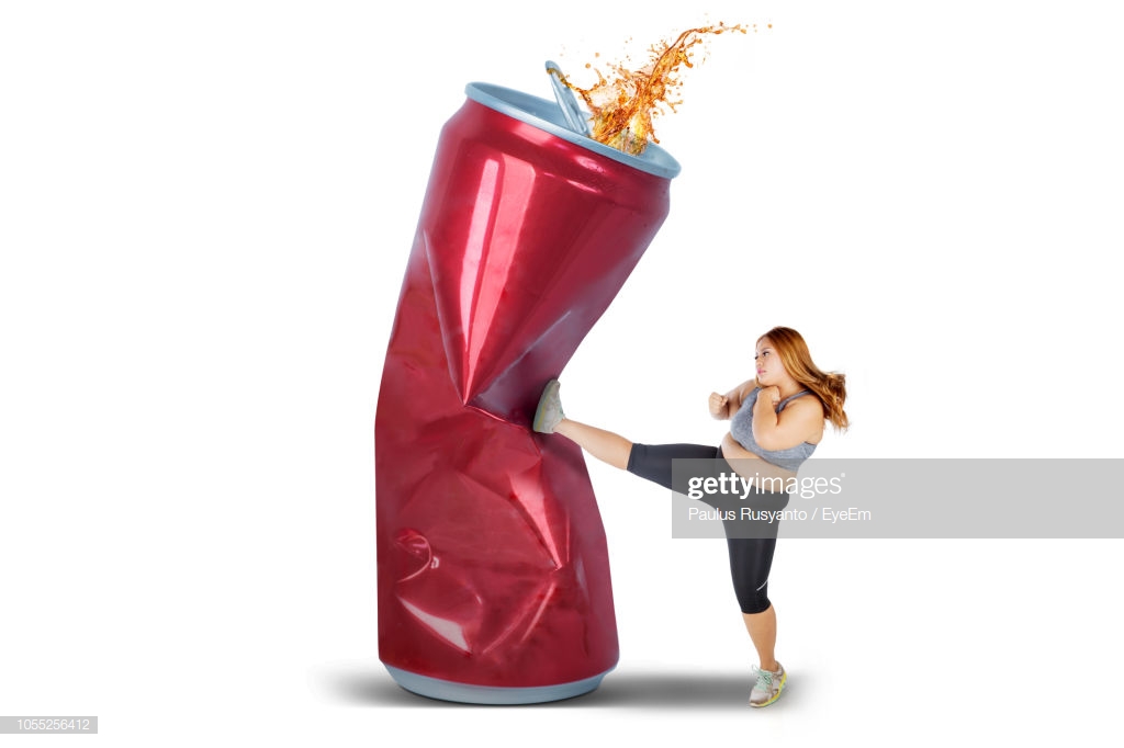 Overweight Woman Kicking Drink Can Over White Background Stock