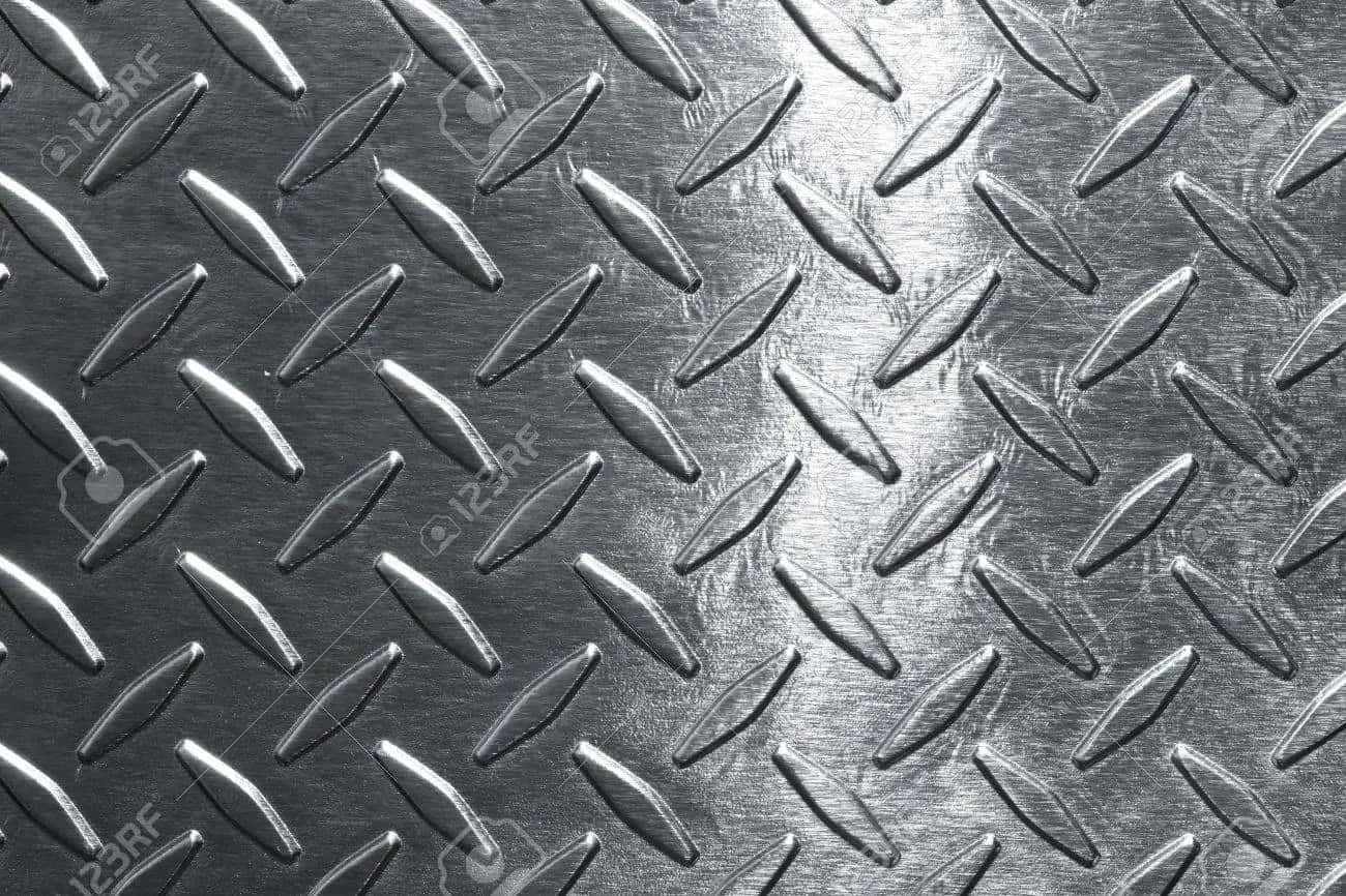 A Close Up Of Metal Plate With Diamonds Wallpaper
