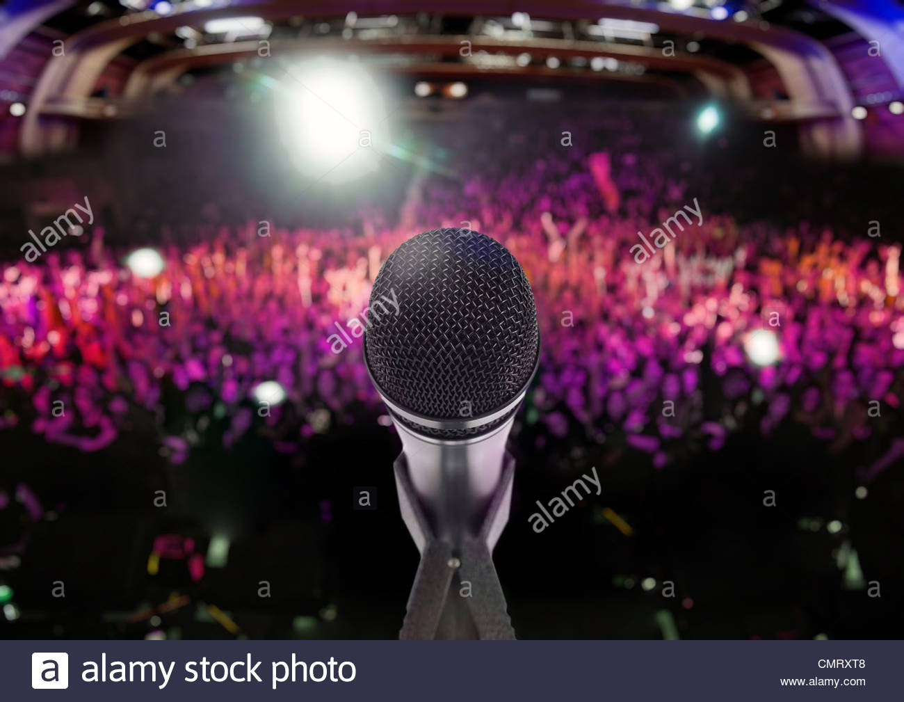 Microphone On Stage With An Audience The Background Stock Photo