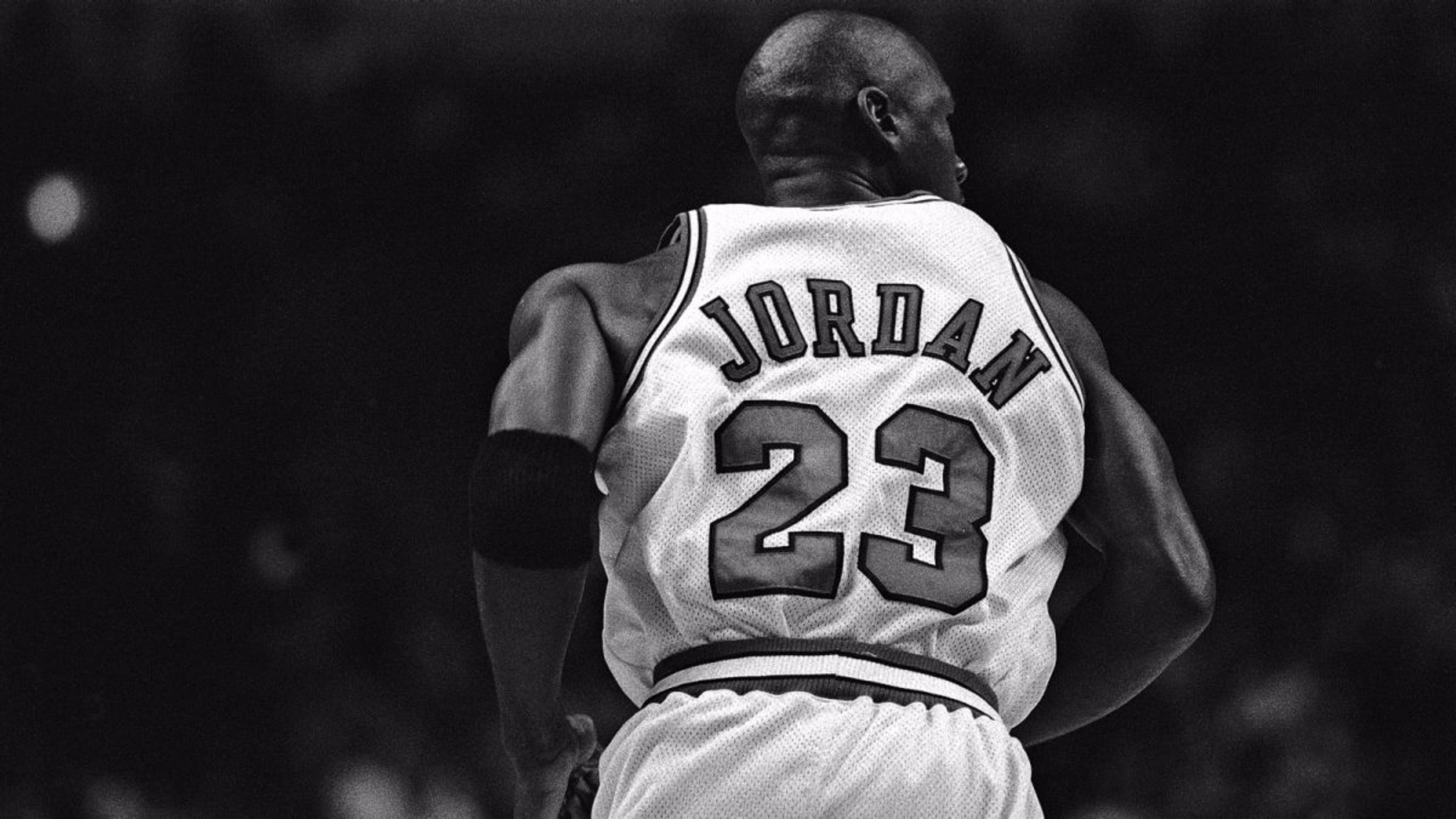 Michael Jordan, number 23, in a black and white action shot during a Chicago Bulls game