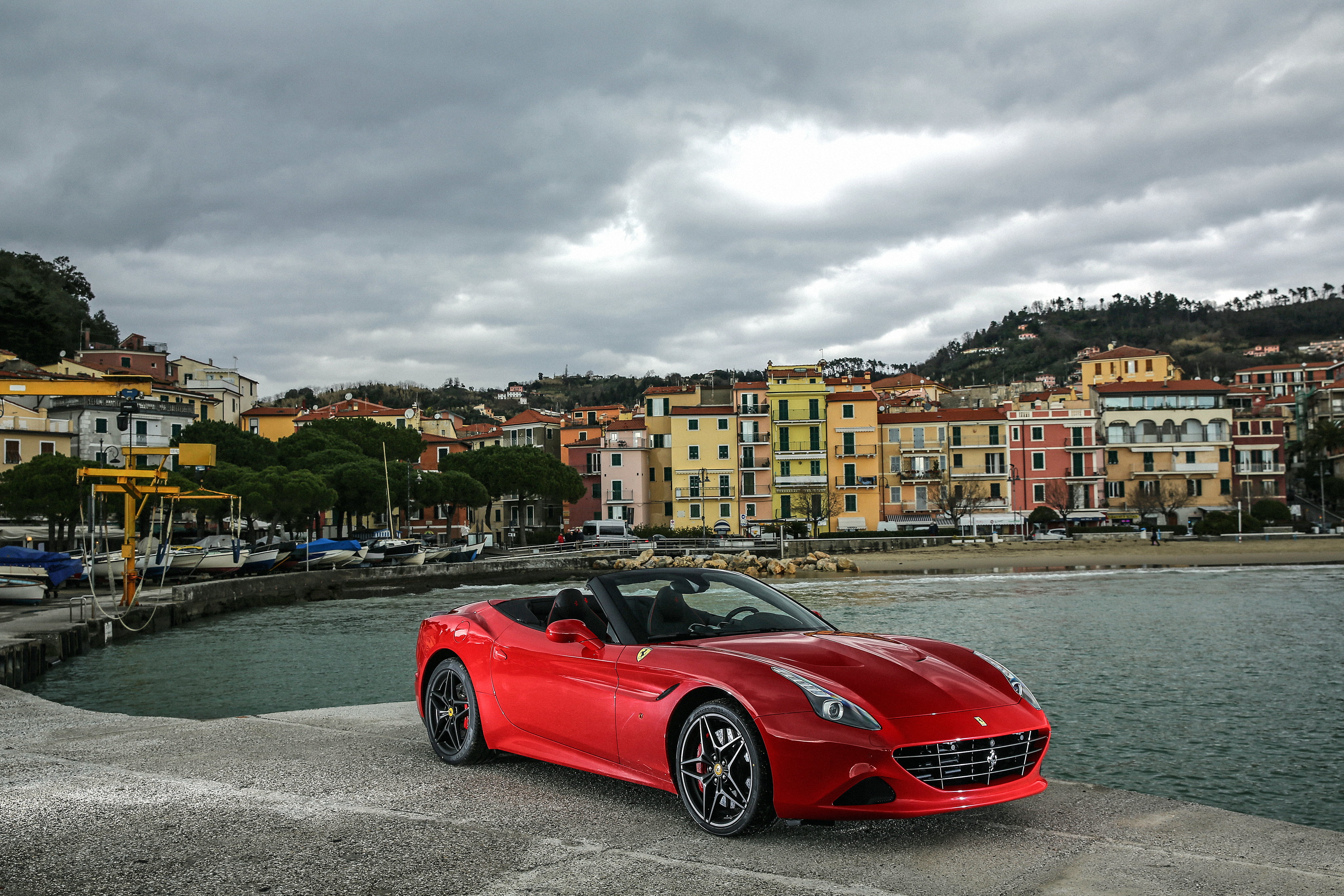 Red Ferrari Italia Convertible Parked On Gray Concrete