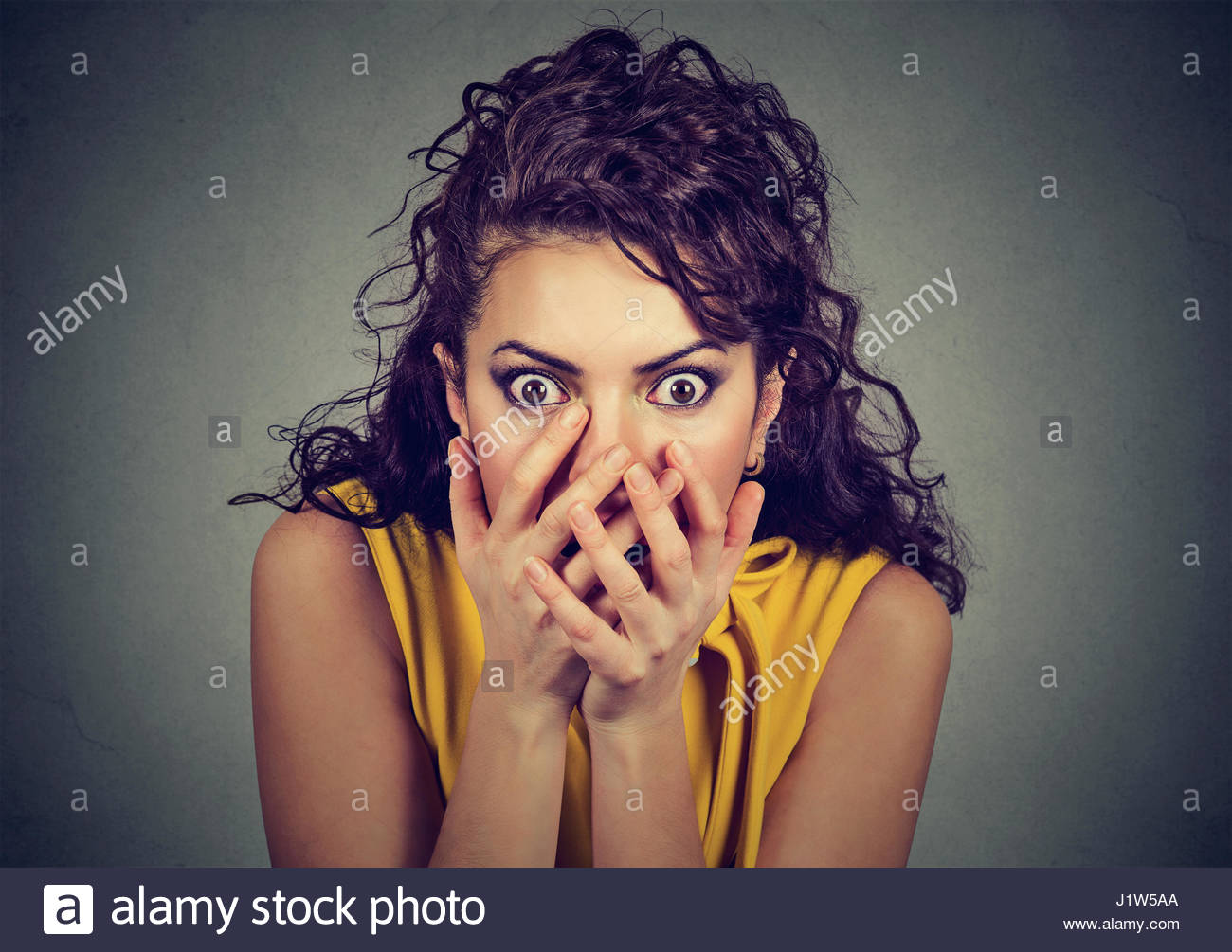 Scared Shocked Woman With Hands Over Her Mouth Isolated On Gray
