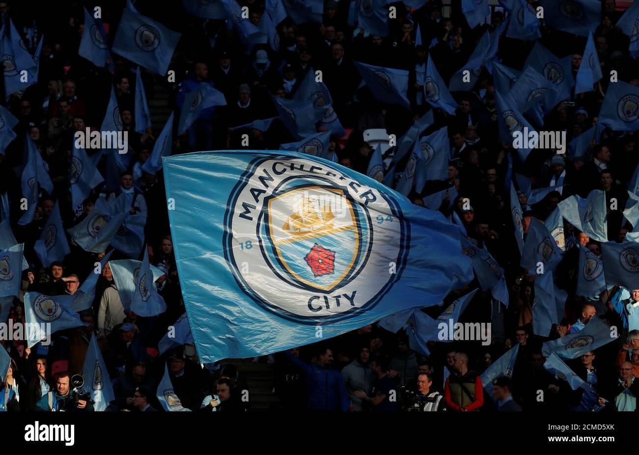 Manchester city fans wave flags hi res stock photography and
