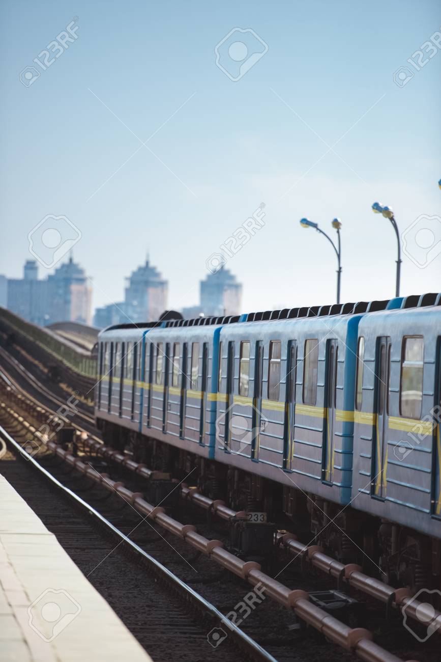 Front Of Train At Outdoor Subway Station With Buildings