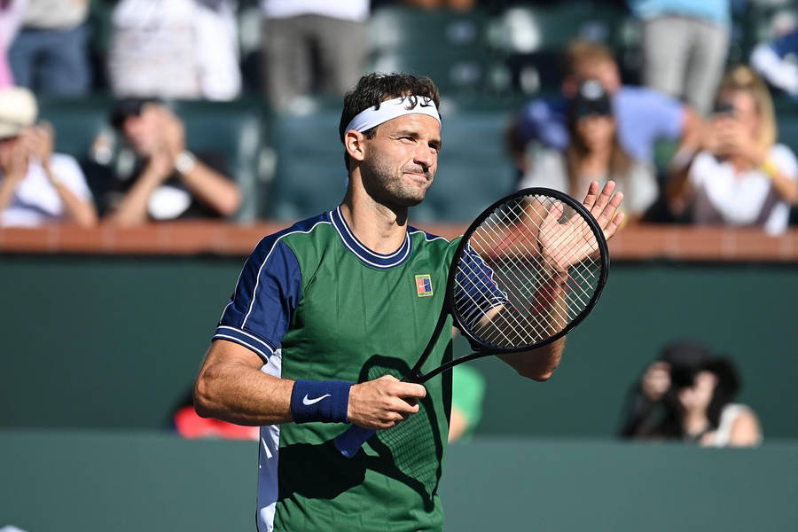 Grigor Dimitrov In Action On A Tennis Court Wallpaper
