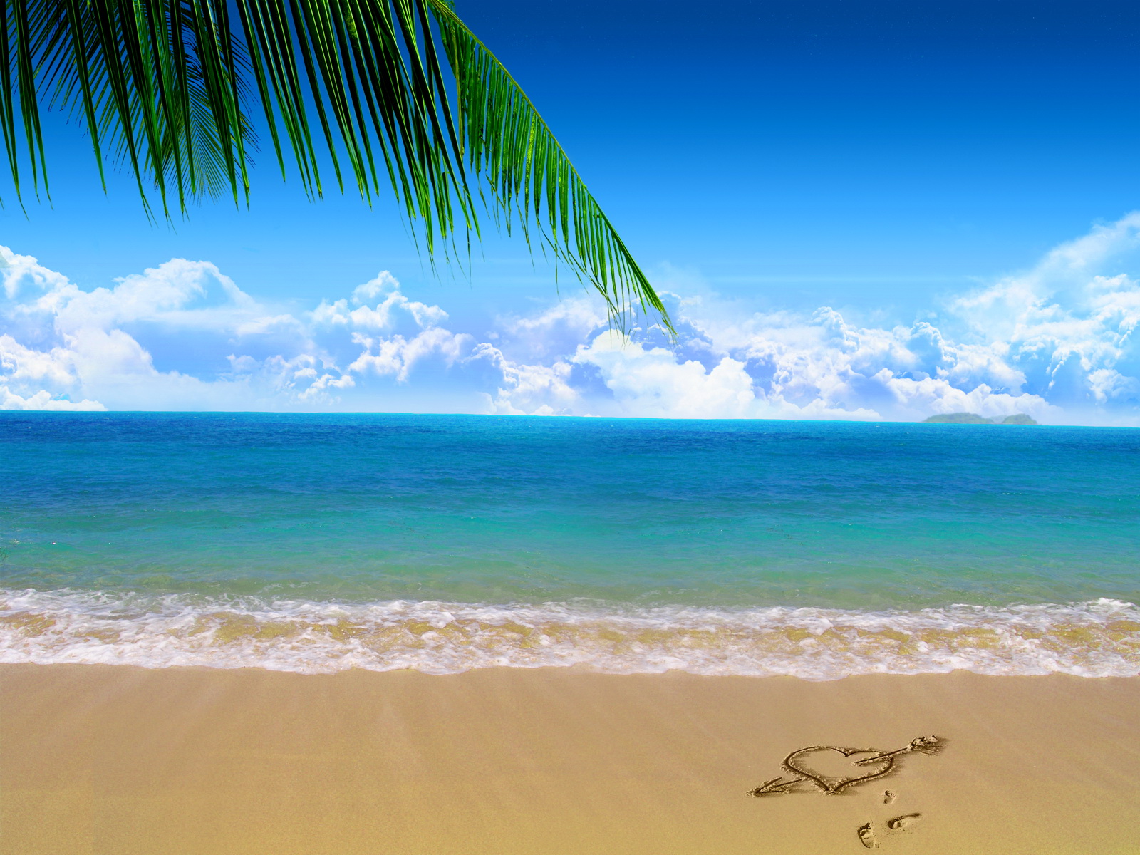 Tropical beach with a heart drawn in the sand, palm tree leaves overhead, and turquoise ocean under blue sky with fluffy clouds