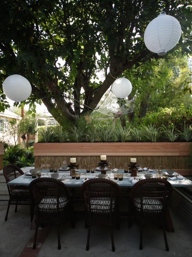 Outdoor Dining Area with Hanging Paper Lanterns and Wicker Chairs