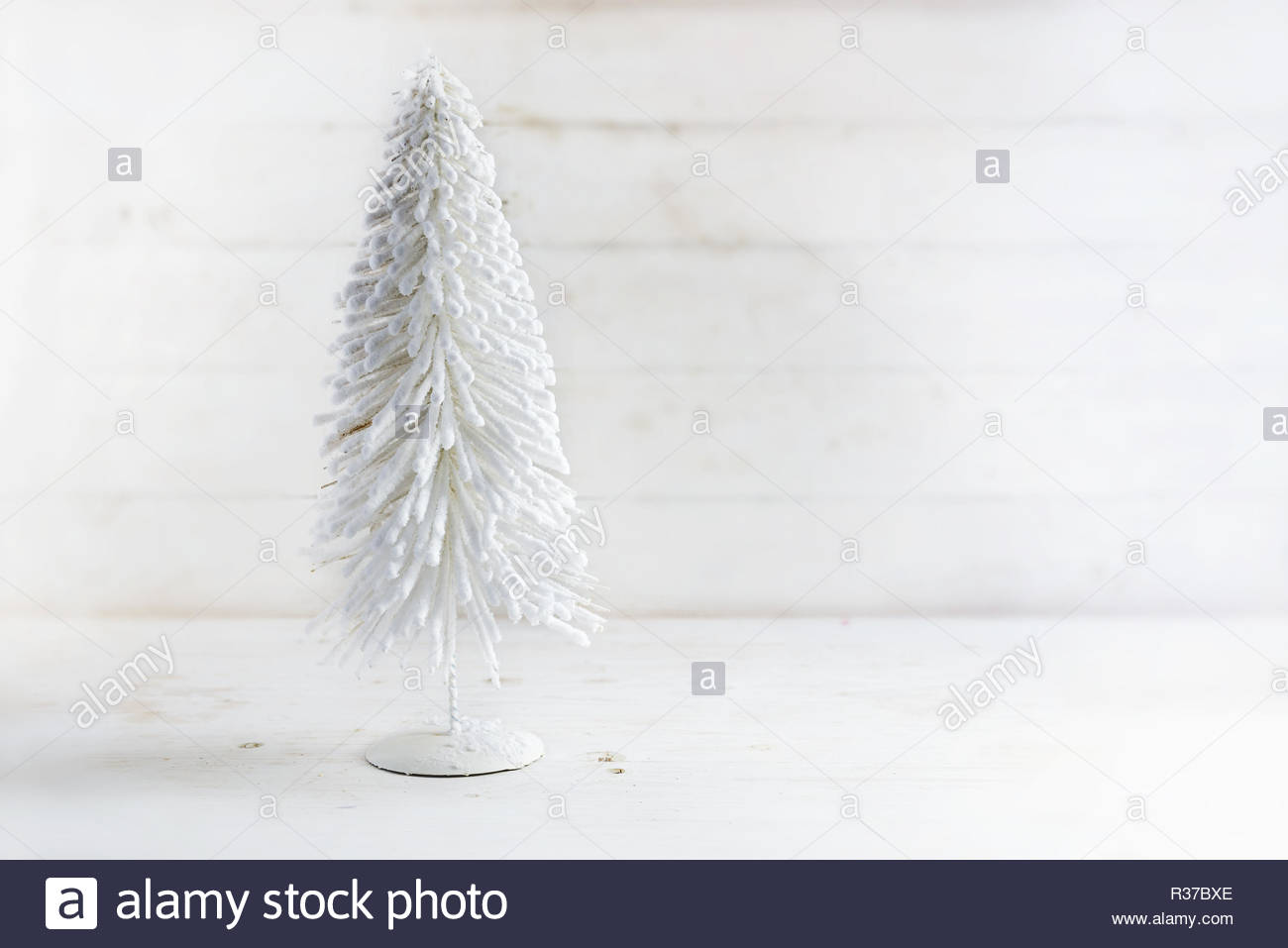 White Artificial Christmas Tree From Flocked Wire On A Rustic