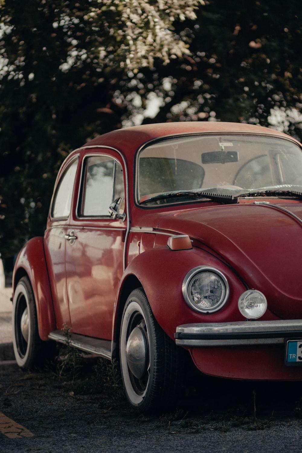 Red Volkswagen Beetle Parked On The Side Of Road Photo