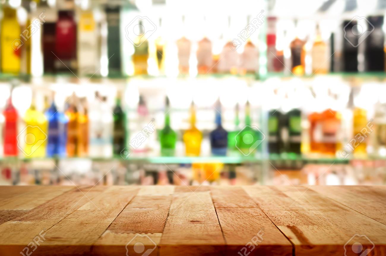 Wood Bar Top On Blur Colorful Alcohol Drink Bottle Background