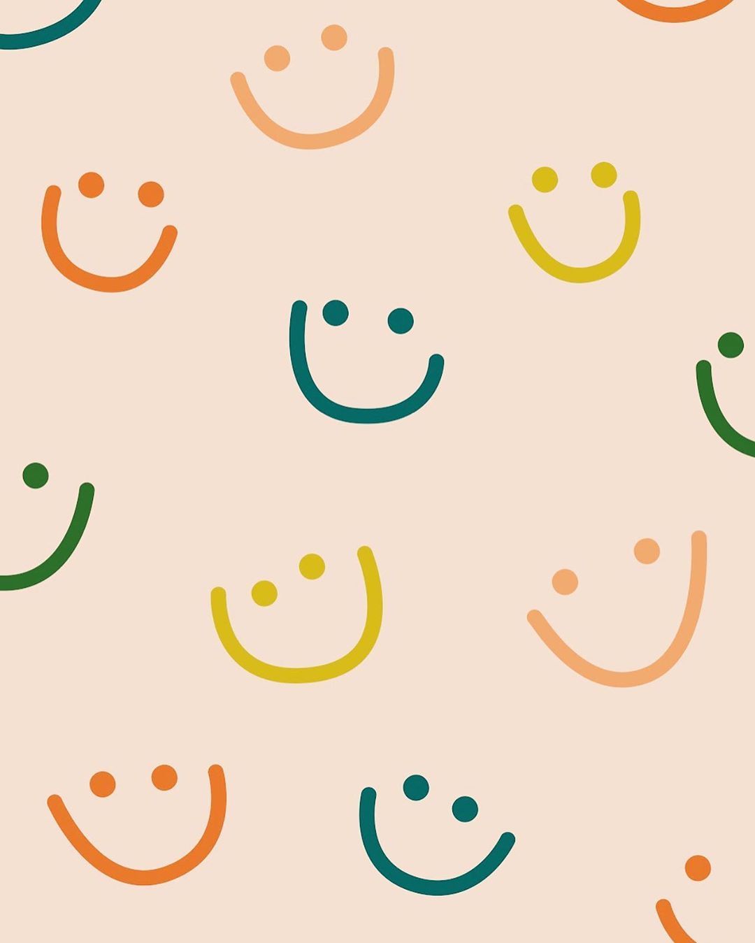 Colorful smiley faces on a light pink background, perfect for a cheerful wallpaper