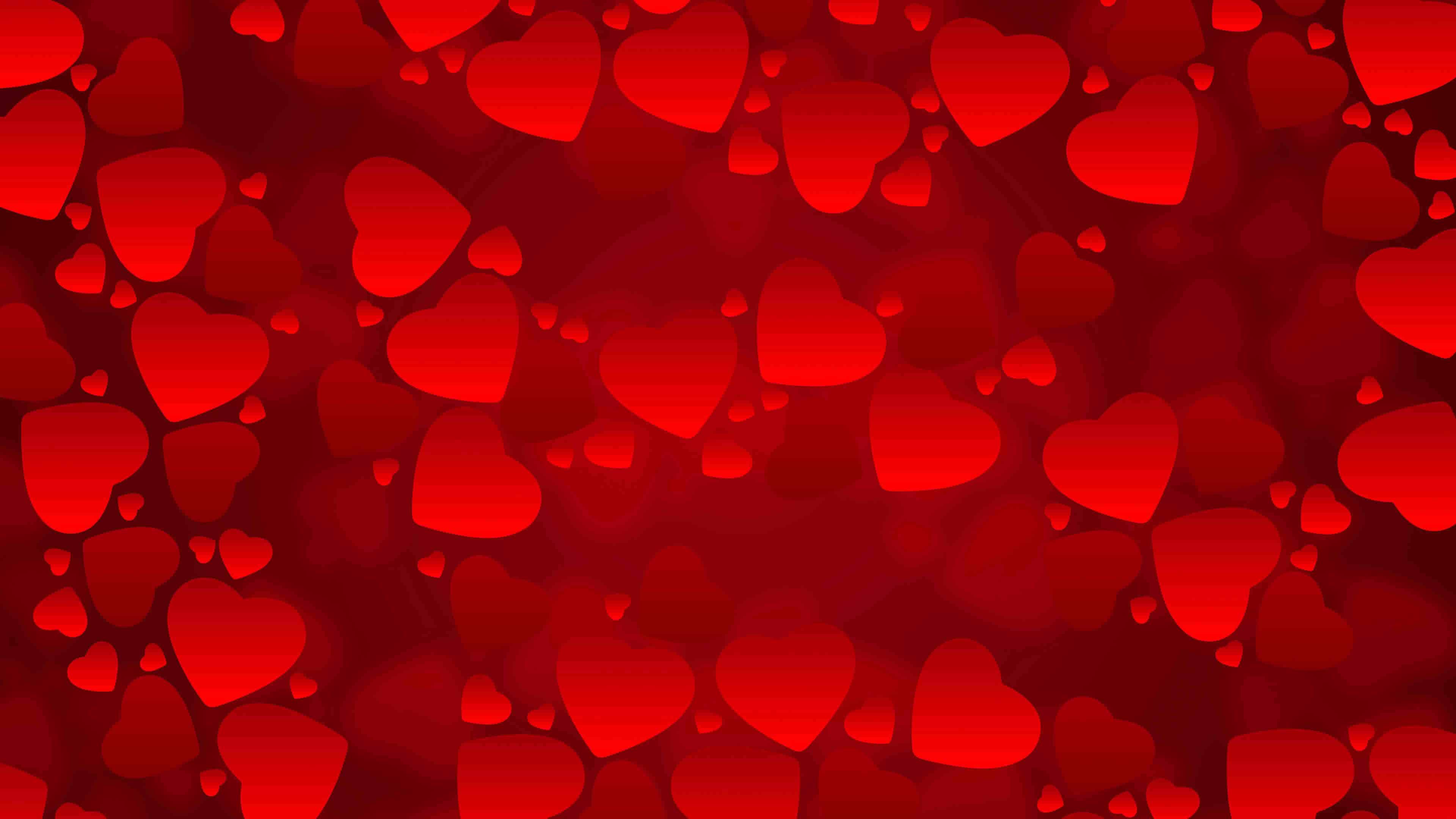 A vibrant Valentine's Day background filled with various sizes of red hearts, perfect for a romantic and festive feel
