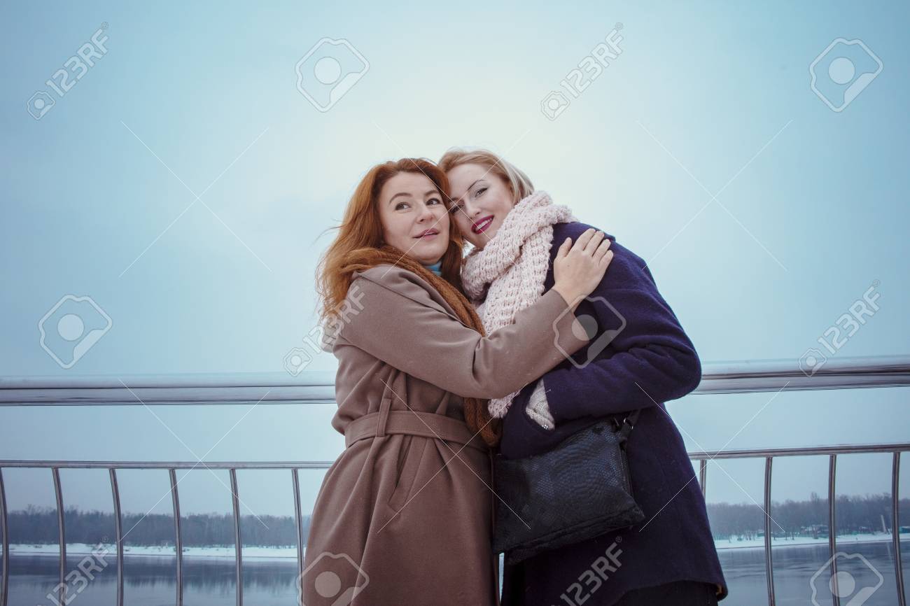 Red Haired Woman And Blonde One Enjoy Socializing With Each Other