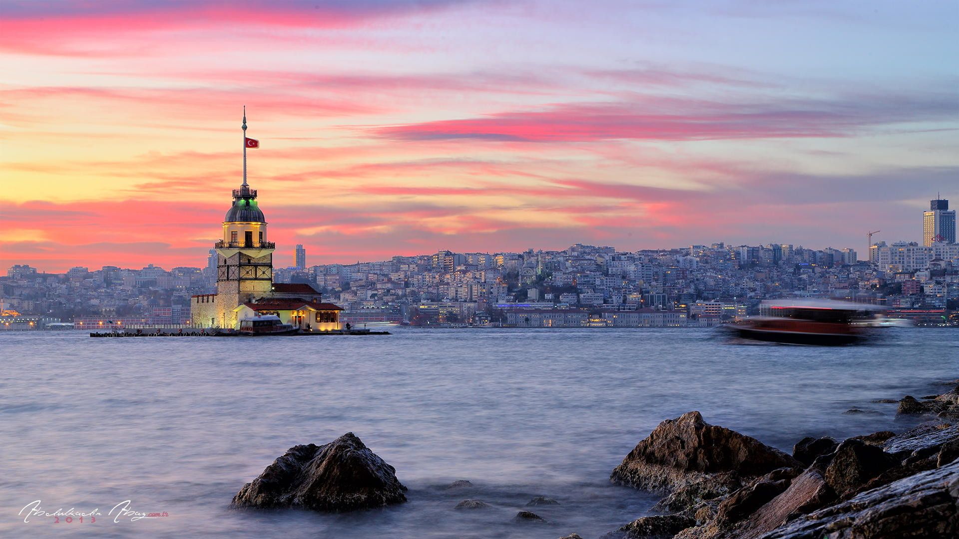 A stunning sunset over the Bosphorus Strait in Istanbul, featuring the Maiden's Tower