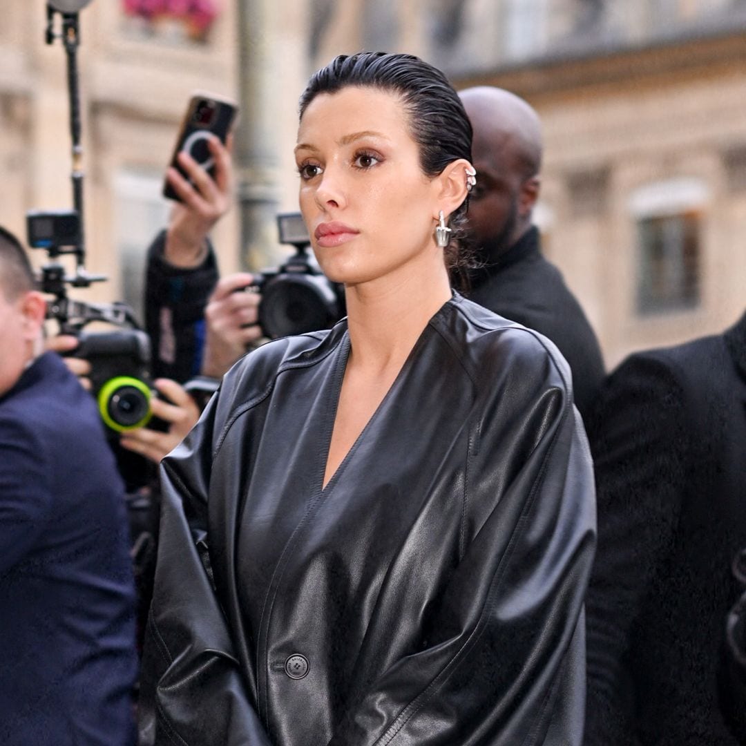 Bianca Censori at a public event, wearing a black leather jacket