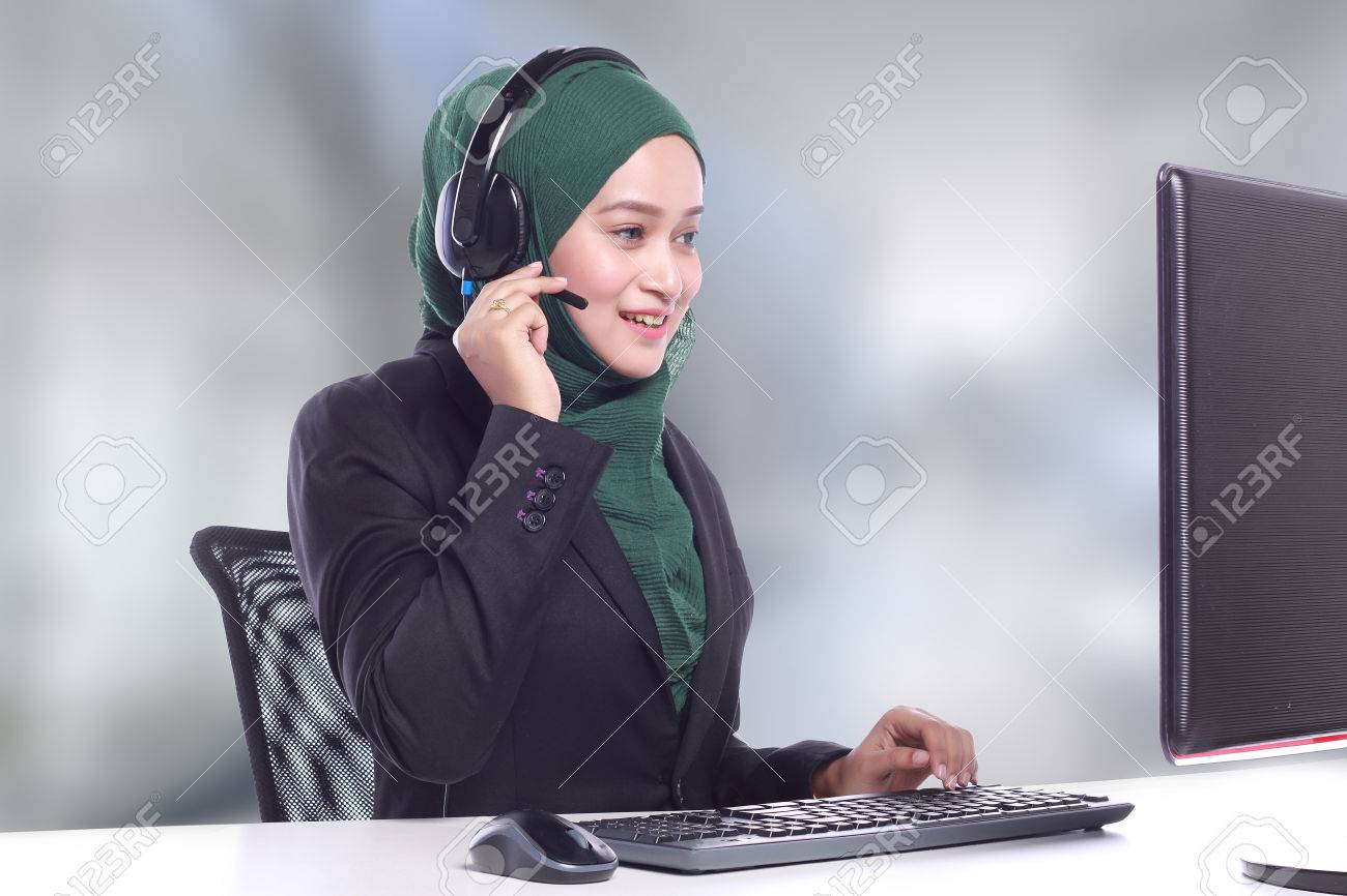 Young Muslim Women Helpline Operator Talking On Blur Background