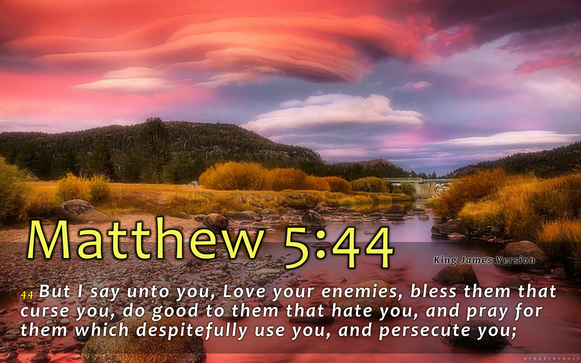 A scenic landscape image with a river flowing through it during sunset, overlaid with the Bible verse Matthew 5:44 about loving your enemies
