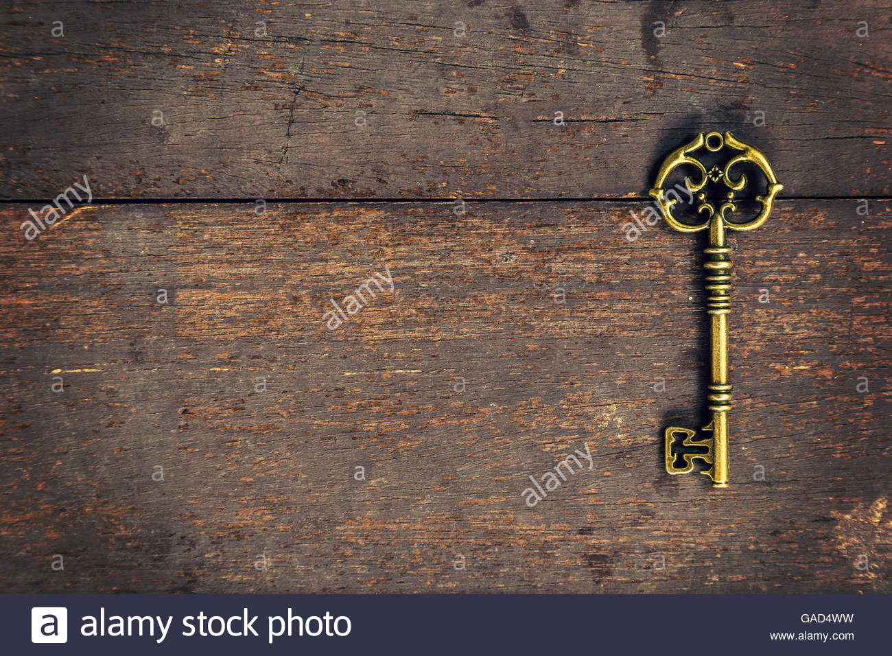 Old Vintage Key On Wood Texture Background With Space Stock Photo