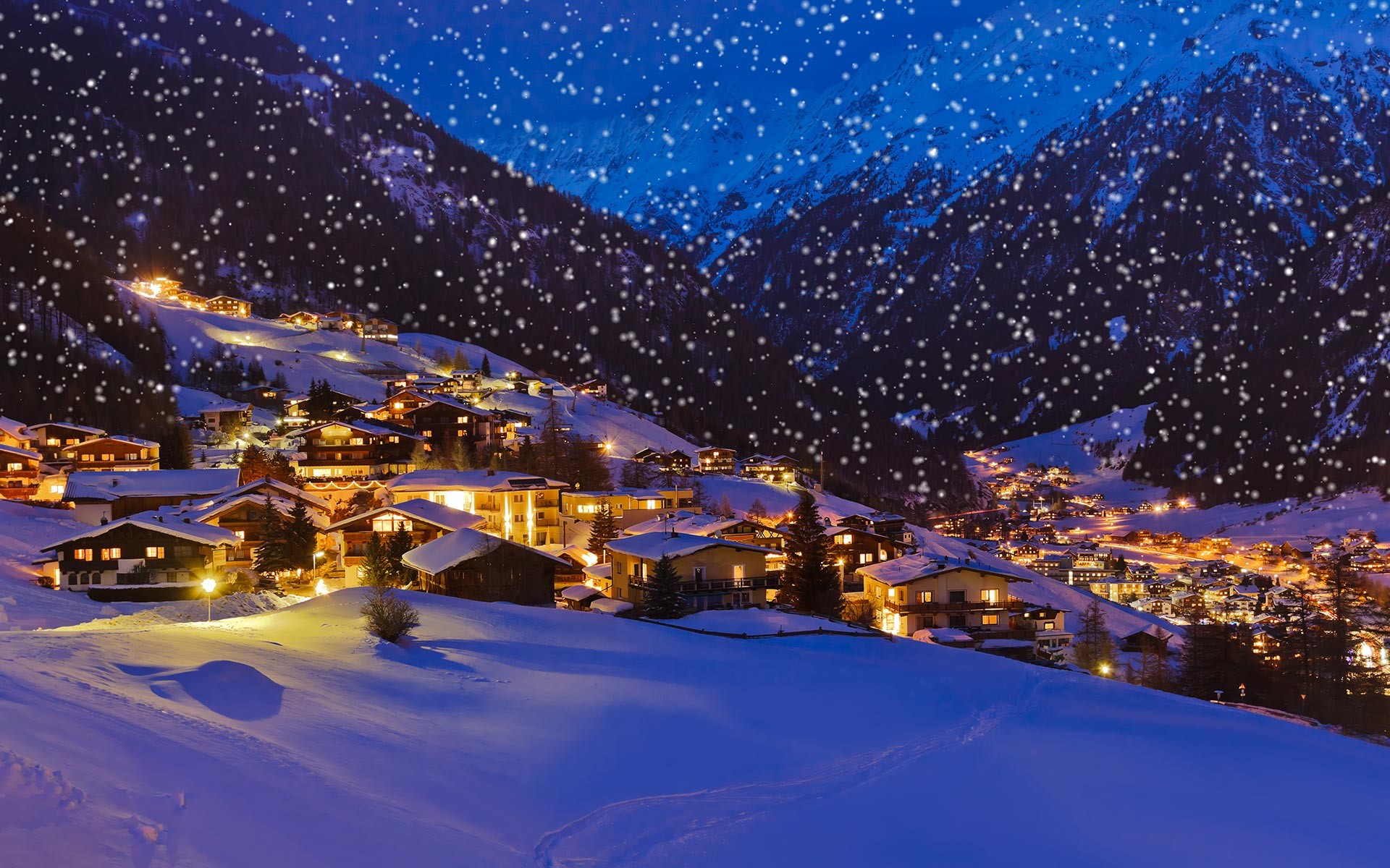 A charming snow-covered village nestled in a valley at twilight, with snowflakes gently falling against a backdrop of majestic, snow-capped mountains. Warm lights illuminate the cozy chalets, creating a picturesque winter wonderland scene