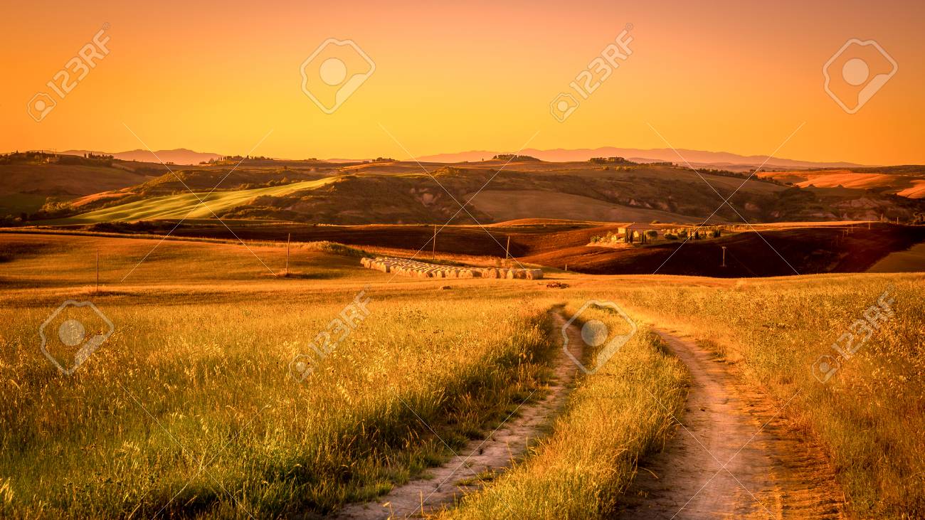 Tuscan Country Road With Haystack In The Background Stock Photo