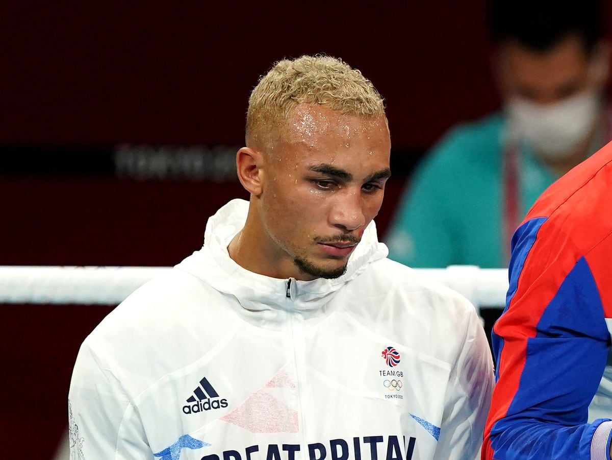 Benjamin Whittaker, a British boxer, looking downwards in a boxing ring, possibly after a match
