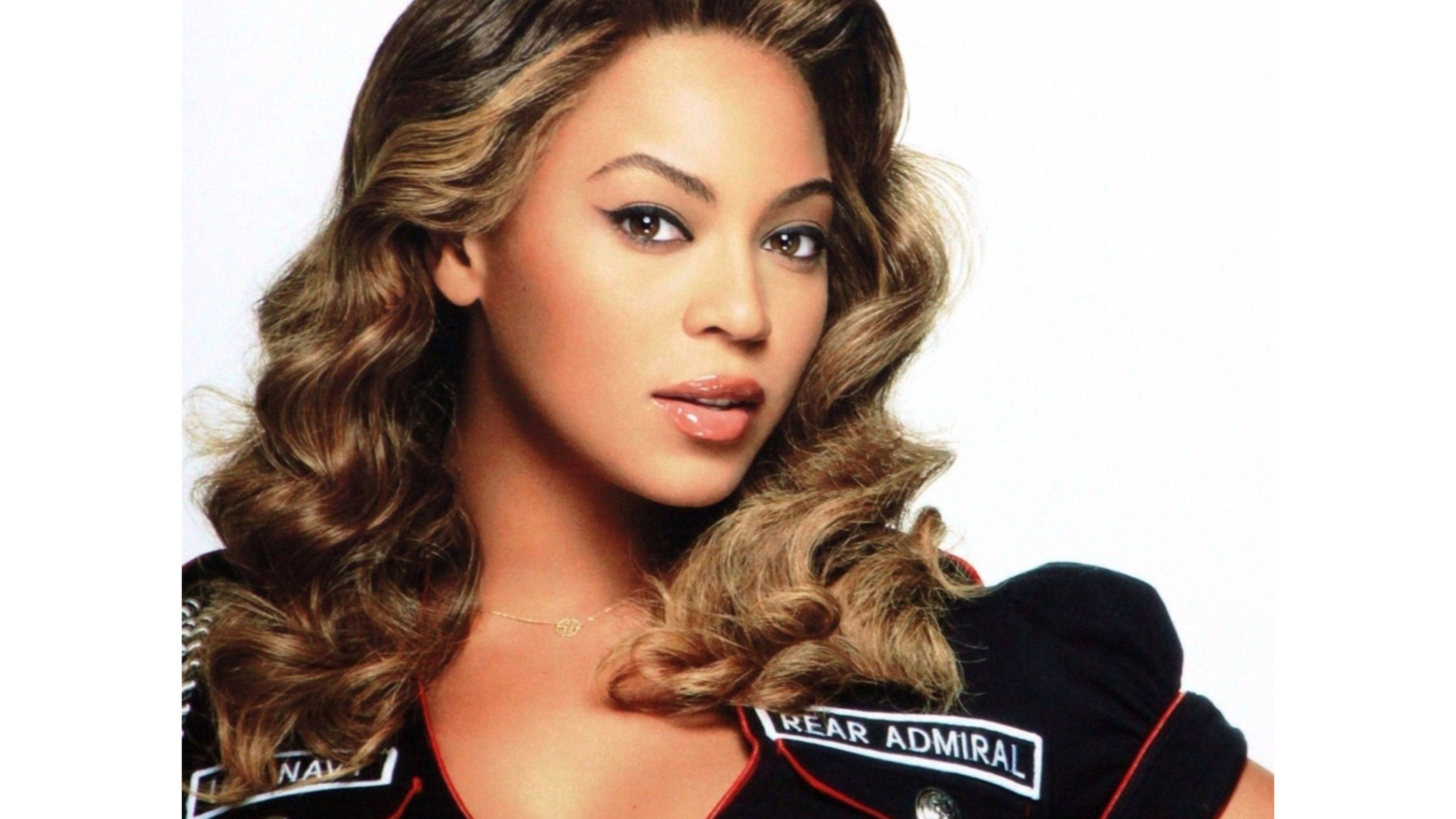 Beyonce Knowles-Carter, close-up portrait with styled hair and naval-inspired attire