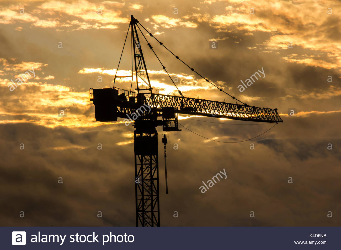 Silhouette Of Tower Crane On Background Sunset Sky Stock Photo