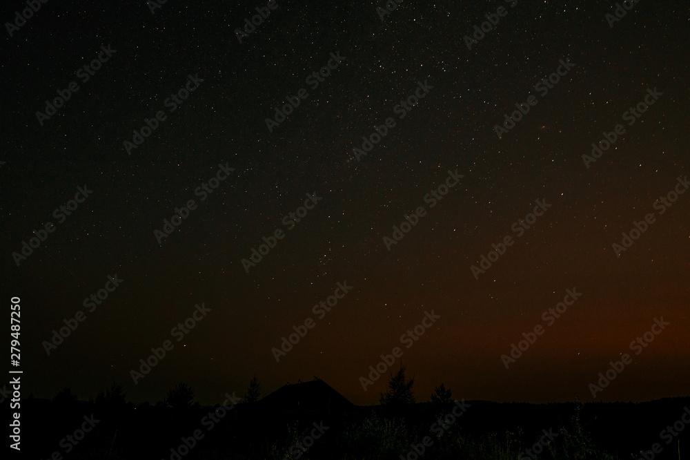 Beautiful At Night Sky With Stars Light And Trees On Hill