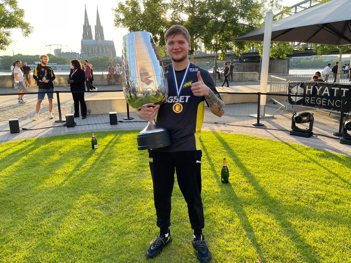 s1mple holding a trophy and giving a thumbs up