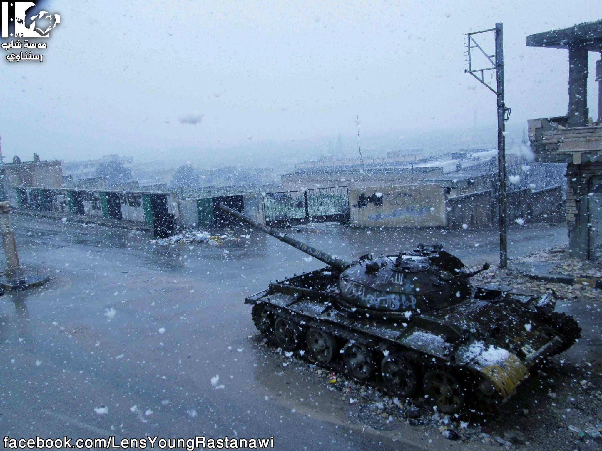 A tank covered in snow in a Syrian city during winter, showcasing the impact of conflict on daily life